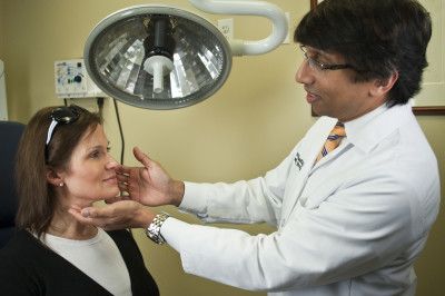 Dr. Prasad examining patient durign consultation